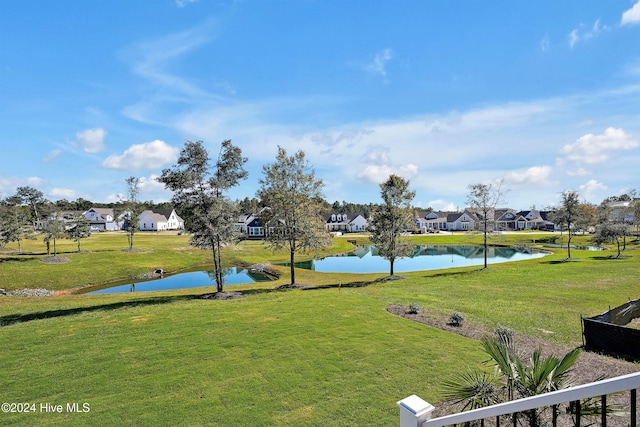 view of community featuring a yard and a water view