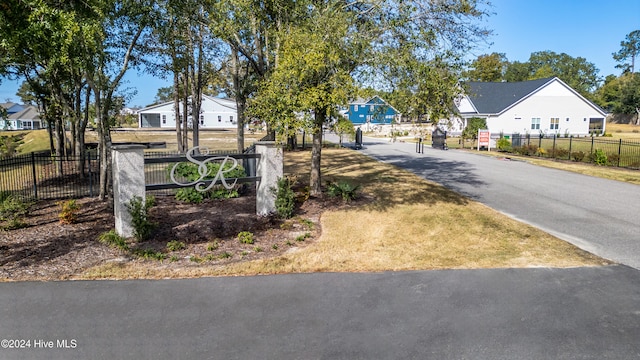 view of road featuring a gated entry and a residential view