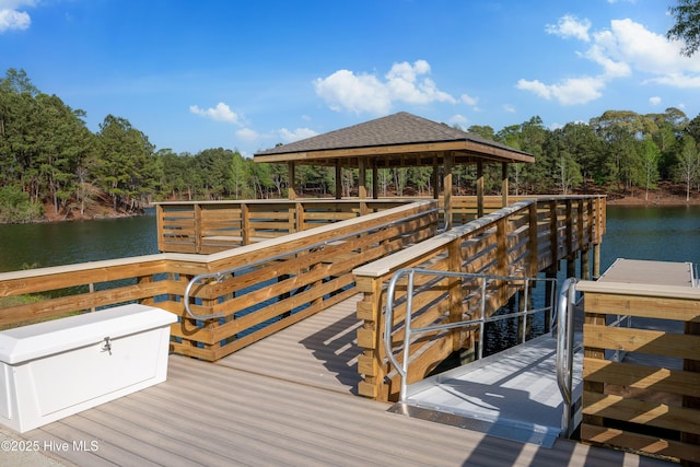dock area with a water view and a forest view
