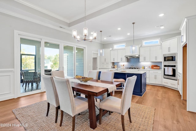 dining space featuring crown molding, light wood-style flooring, a wainscoted wall, recessed lighting, and a notable chandelier