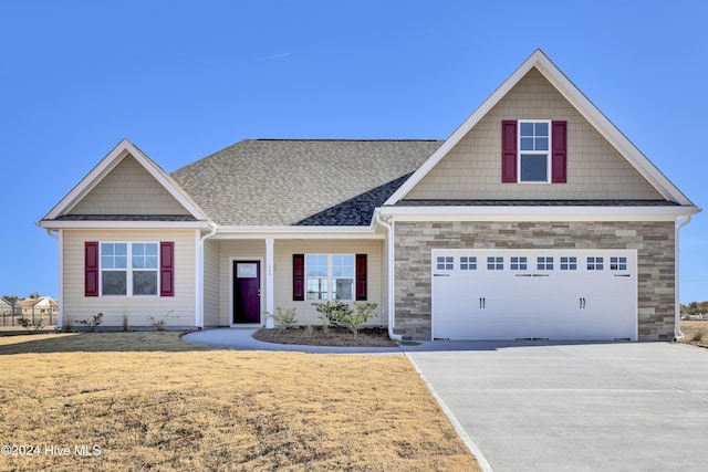 craftsman-style home with a garage and a front lawn