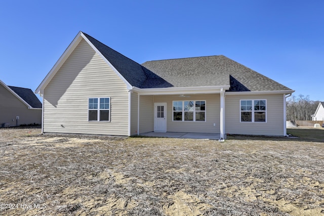 back of property with a patio