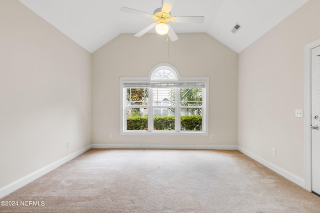 empty room with ceiling fan, light colored carpet, and lofted ceiling