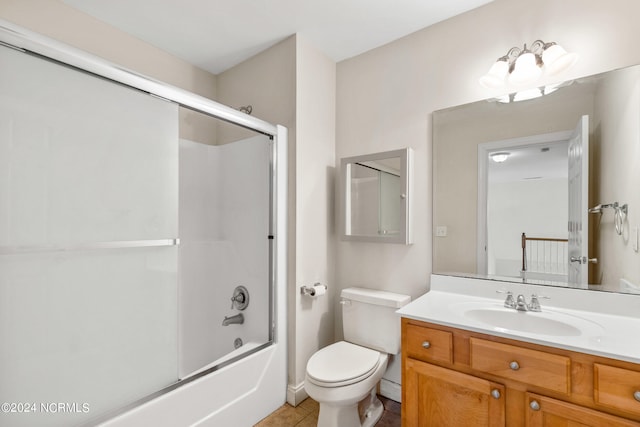 full bathroom with shower / bath combination with glass door, tile patterned flooring, vanity, and toilet