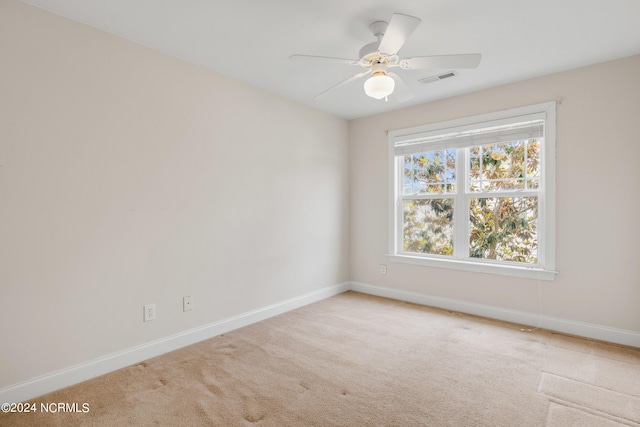 carpeted empty room with ceiling fan