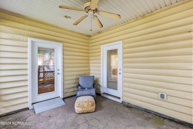 property entrance with ceiling fan and a patio