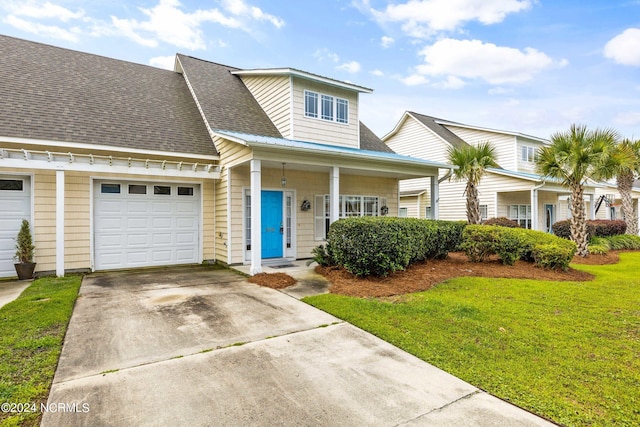 view of front of property featuring a garage and a front lawn