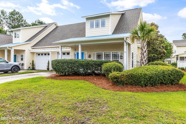 view of front of house featuring a garage and a front lawn