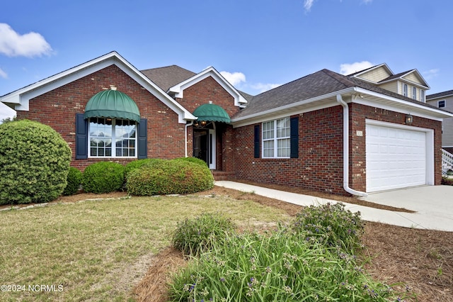 view of front of property featuring a garage and a front yard