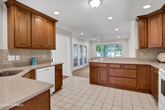 kitchen featuring ceiling fan, sink, tasteful backsplash, crown molding, and white appliances