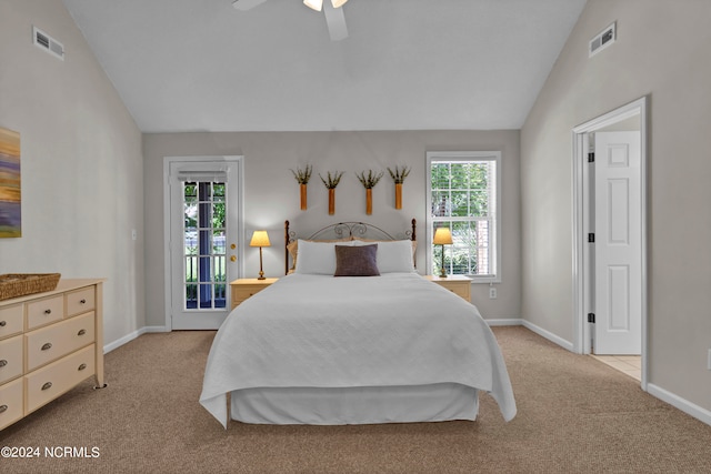 carpeted bedroom featuring ceiling fan, access to exterior, multiple windows, and vaulted ceiling