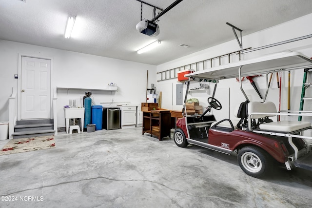 garage featuring electric panel and a garage door opener