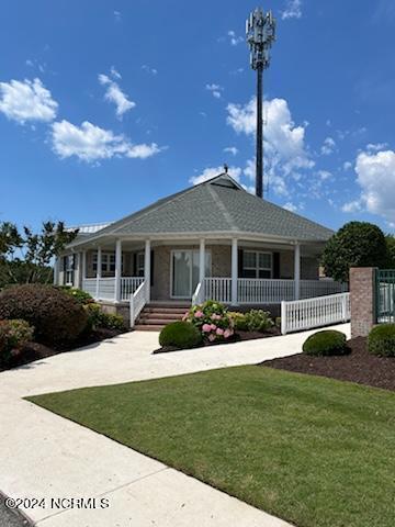 view of front facade featuring a front lawn and covered porch