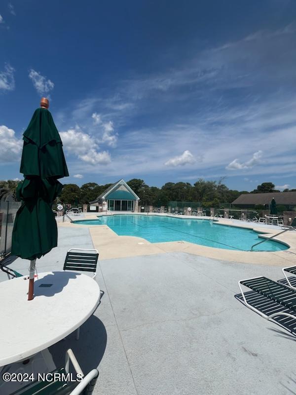 view of swimming pool featuring a patio area