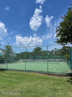 view of sport court with a lawn