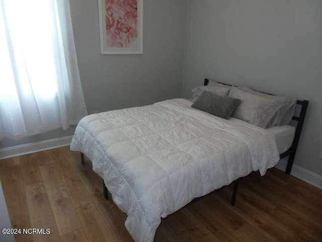 bedroom with hardwood / wood-style floors