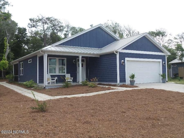 view of front of house with a garage and covered porch