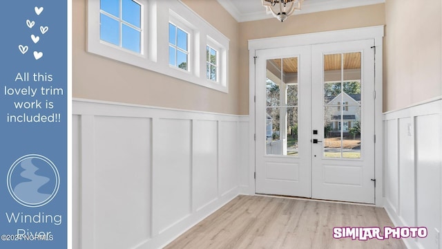 entryway with light hardwood / wood-style flooring and crown molding