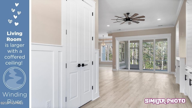 interior space with crown molding, ceiling fan, and light hardwood / wood-style floors