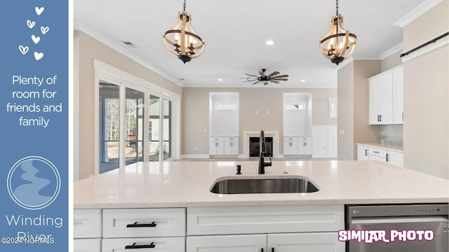 kitchen featuring sink, stainless steel dishwasher, pendant lighting, white cabinets, and ceiling fan with notable chandelier