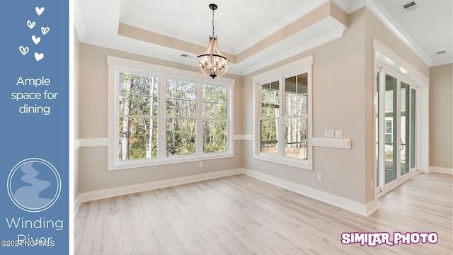 unfurnished sunroom with a notable chandelier and a tray ceiling