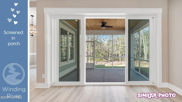 doorway featuring hardwood / wood-style floors, wooden ceiling, and ceiling fan with notable chandelier