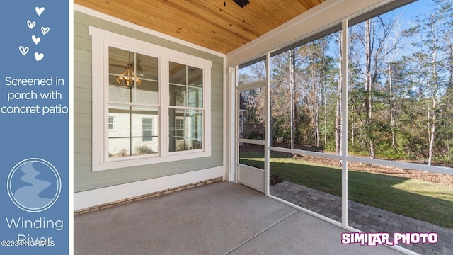 unfurnished sunroom featuring wood ceiling and a chandelier