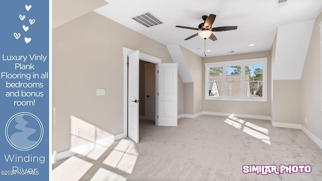 unfurnished bedroom with ceiling fan, lofted ceiling, and light carpet