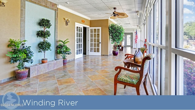 sunroom featuring french doors and ceiling fan