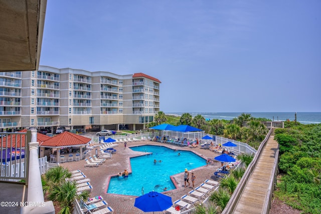 view of swimming pool featuring a gazebo, a patio area, and a water view