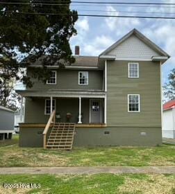 back of house featuring a lawn, covered porch, and crawl space