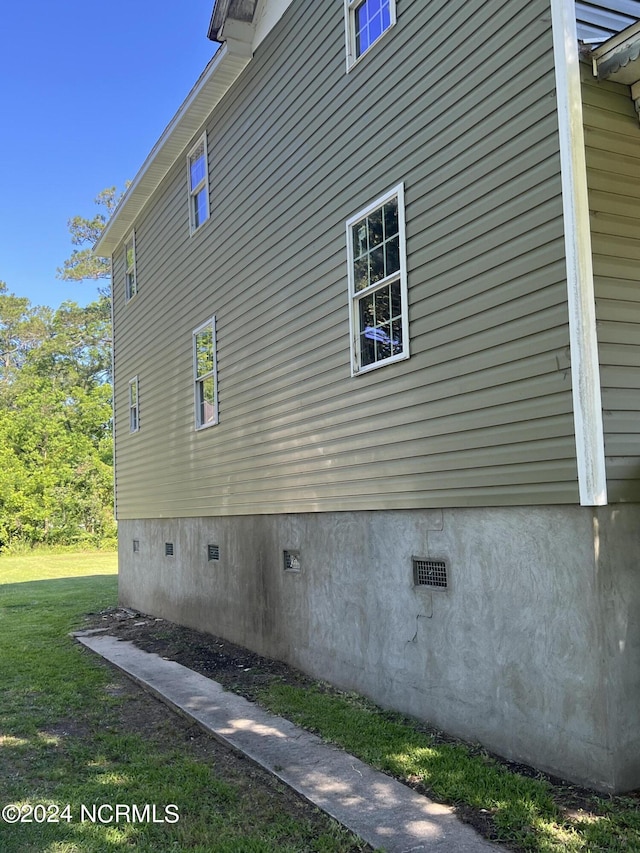 view of property exterior featuring crawl space and a yard