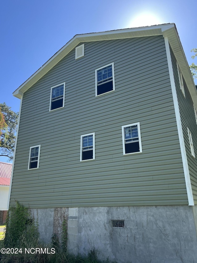 view of side of home featuring crawl space