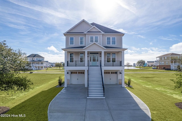 view of front facade with a porch, a garage, and a front lawn