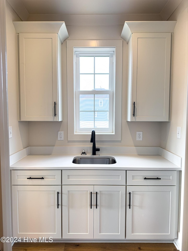 kitchen featuring white cabinetry and sink