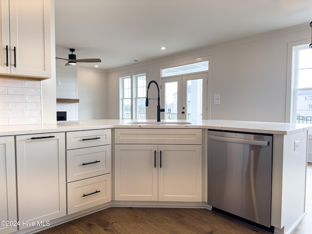 kitchen featuring kitchen peninsula, french doors, white cabinets, sink, and dishwasher