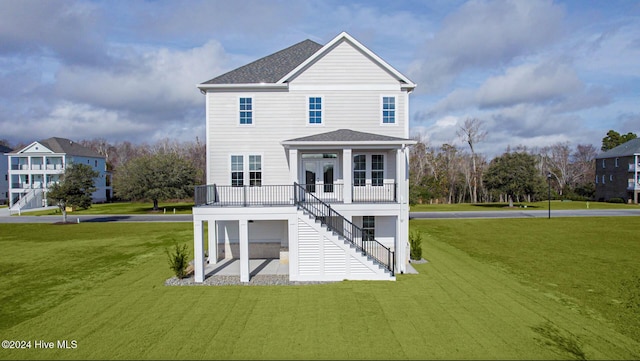 rear view of house with a lawn and a patio area