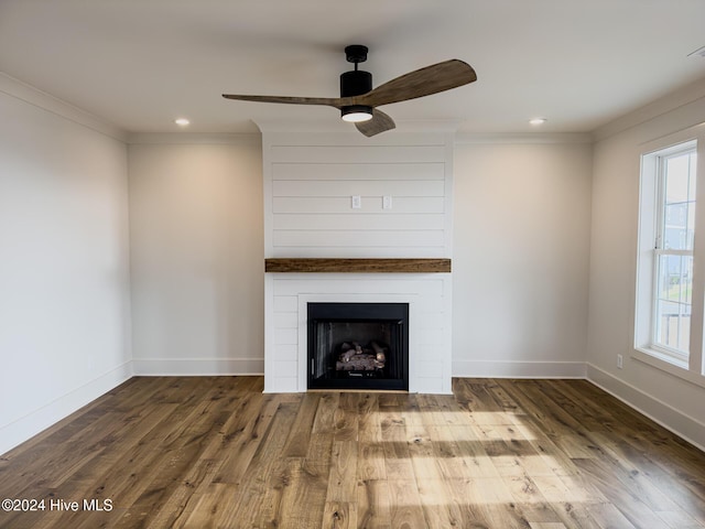 unfurnished living room featuring hardwood / wood-style floors, ceiling fan, crown molding, and a wealth of natural light