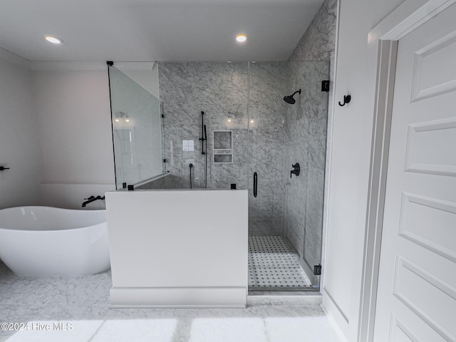 bathroom featuring separate shower and tub