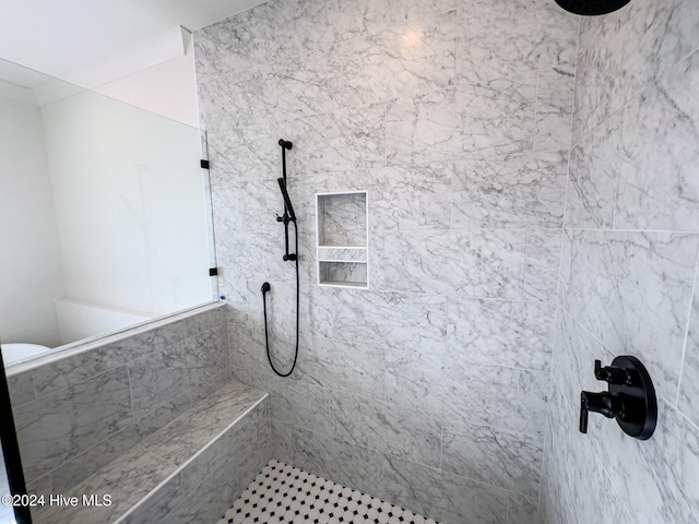 bathroom with a tile shower