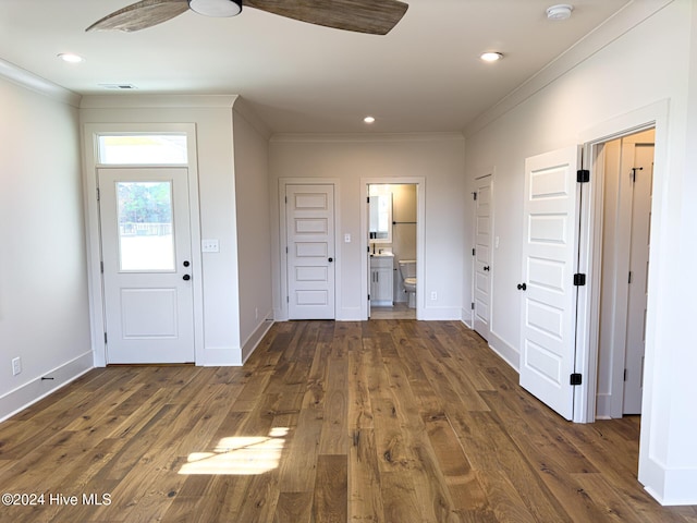 interior space featuring ornamental molding and dark wood-type flooring