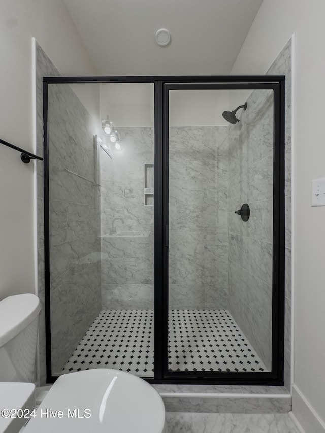 bathroom with a shower with shower door