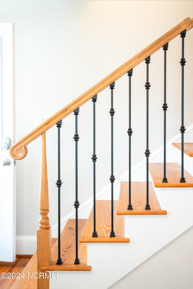 staircase featuring hardwood / wood-style flooring