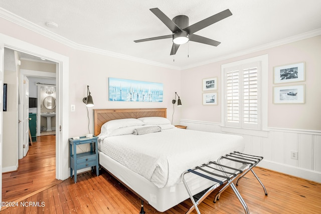 bedroom with ceiling fan, ornamental molding, and light hardwood / wood-style floors