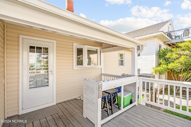 wooden deck featuring central AC unit