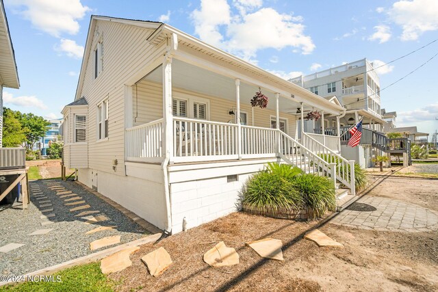 view of front of property featuring central AC unit and covered porch