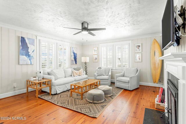 living room featuring plenty of natural light, ceiling fan, and hardwood / wood-style floors