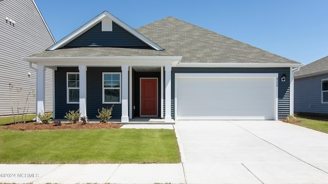 view of front of property with a garage and a front lawn