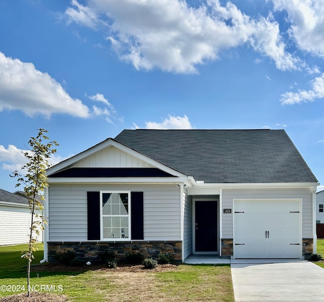 view of front of house with a front yard and a garage