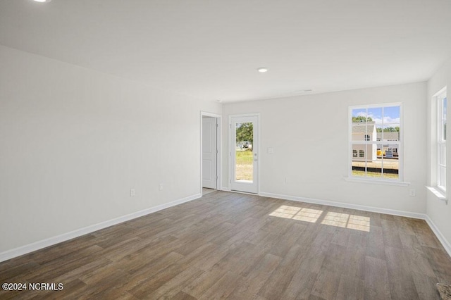 spare room featuring hardwood / wood-style floors and a healthy amount of sunlight